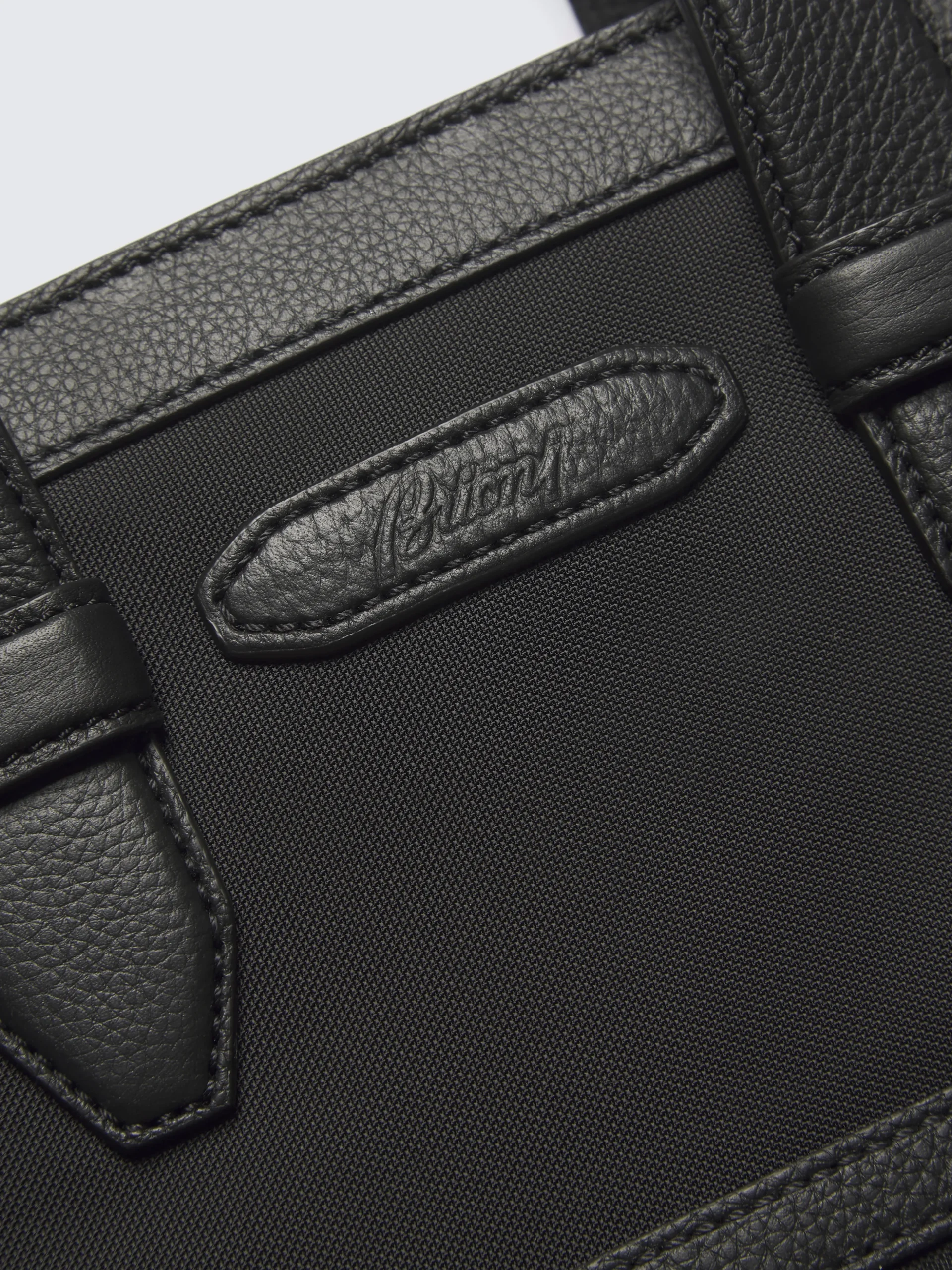 Black nylon and grained leather garment bag